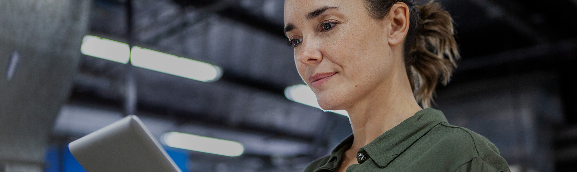 Woman looking at a tablet in a warehouse