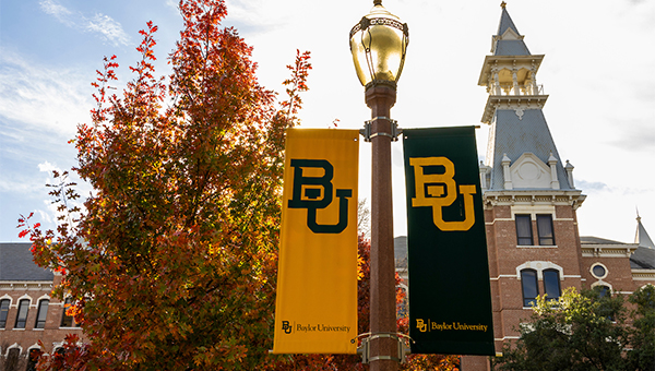Baylor University banners hanging from a campus lampost