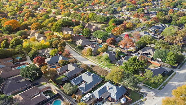 Ariel View of homes with trees in between 