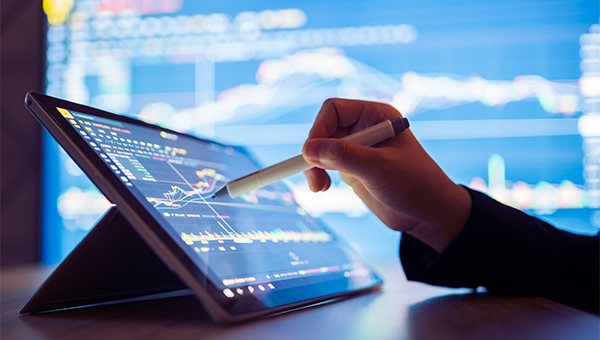Individual reviewing analytics data using a stylus on a tablet Individual reviewing analytics data using a stylus on a tablet