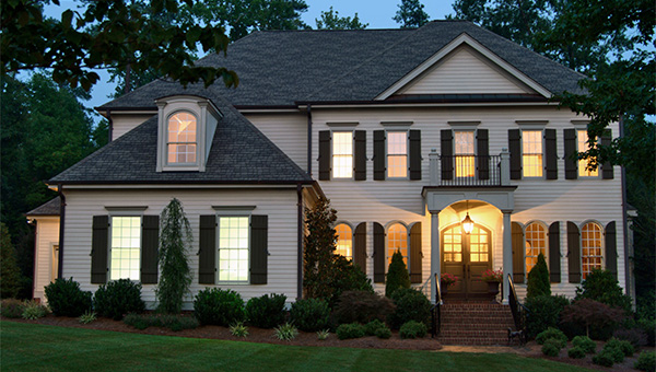 Front of a two story home at dusk with the house lights on Front of a two story home at dusk with the house lights on