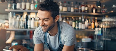 business owner smiling at his phone