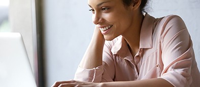 Happy woman looking at computer