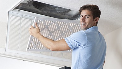 Man replacing air filter.