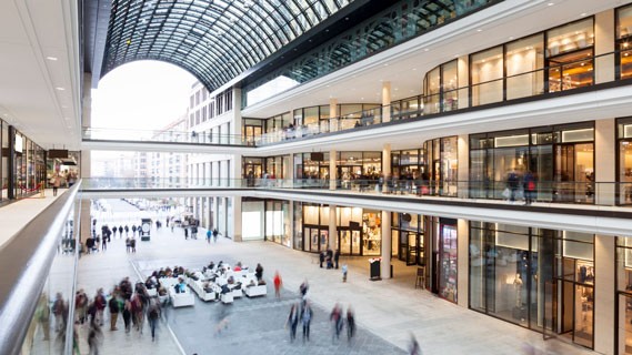 Photo of a mall with people walking everywhere.