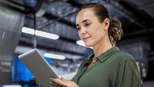 Woman reading a tablet in a warehouse