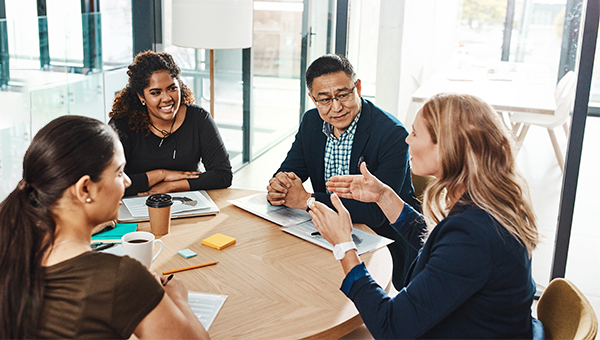 Co-workers sitting at a round table during a meeting