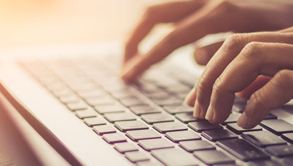 Hands typing on a keyboard