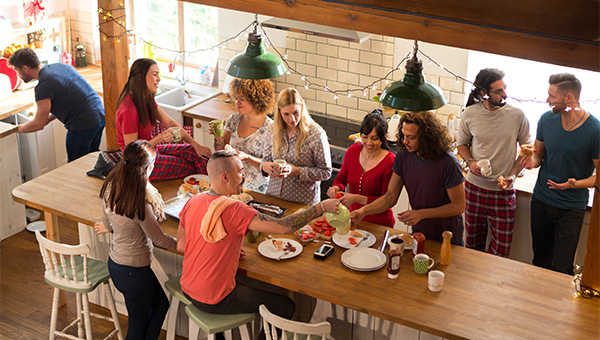 Group of adults having breakfast in their home together