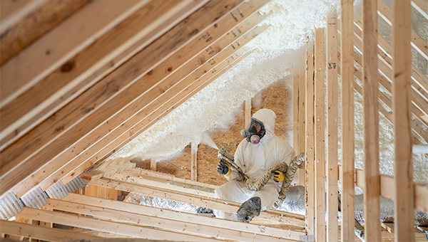 Man installing ceiling insulation