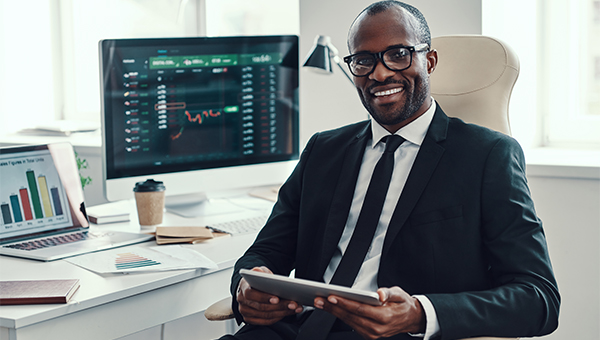 Employee smiling while working looking at charts