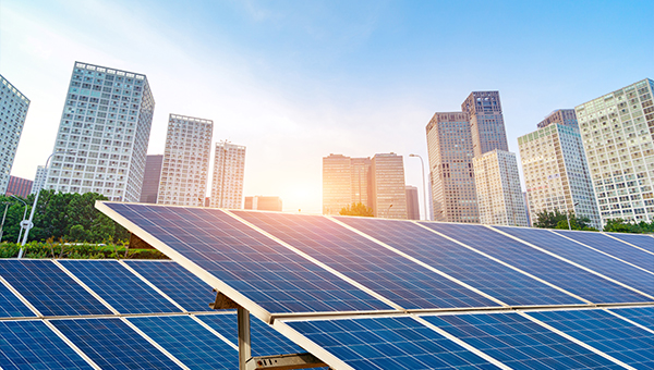 Solar panels in front of a city skyline